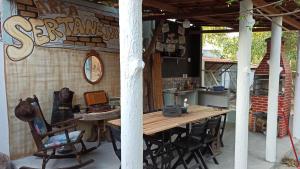 a wooden table and chairs on a patio at Quitinetes Beira Rio in Canindé de São Francisco