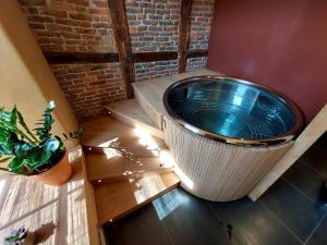 a large tub sitting in the corner of a room at Les Suites de Petit Bomal in Durbuy