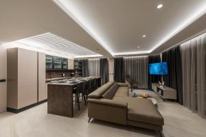 a living room with a couch and a table and a kitchen at Vila Aurelia 1 in Makarska