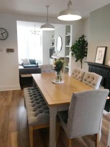 a living room with a wooden table and chairs at Emerson House. Close to Poole Harbour & Town Centre in Poole