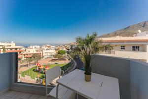 a balcony with a table and a view of a city at 303. MODERN, SUNNY IFONCHE WITH WiFi in Adeje