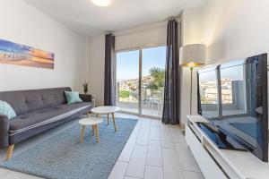 a living room with a couch and a tv at 303. MODERN, SUNNY IFONCHE WITH WiFi in Adeje