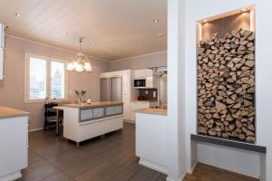 a kitchen with a pile of fire wood on the wall at The Grey House in Kokkola
