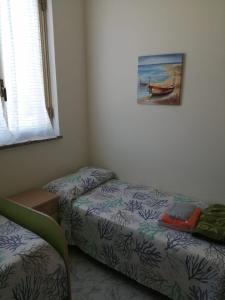 Postel nebo postele na pokoji v ubytování Casa vacanze Le Dune