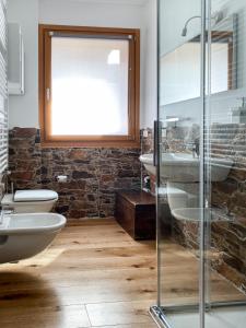 a bathroom with two sinks and a glass shower at Great Escapes in Ponte di Legno
