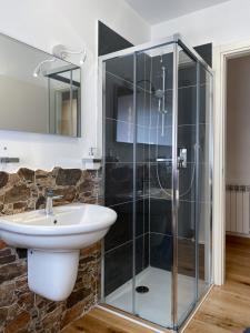 a bathroom with a glass shower and a sink at Great Escapes in Ponte di Legno +17 photos