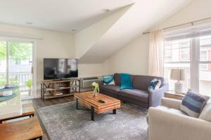 a living room with a couch and a tv at *Cozy Studio Carriage House- Minutes from Downtown in Indianapolis