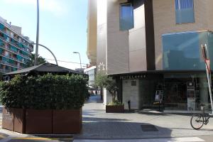 a building with an umbrella on a city street at Hotel Madanis in Barcelona