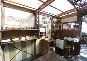 a restaurant kitchen with a counter and a window at Studio Mazo The Glamping in Lodero