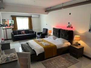 a bedroom with a large bed and a living room at Tiana Boutique in Mağusa