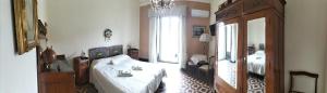 a bedroom with a bed and a large window at B&B Chapo in Catania