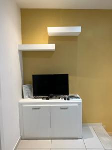 a white cabinet with a television on top of it at St. Elmo Apartments in Valletta