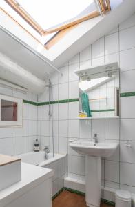 a white bathroom with a sink and a mirror at Petit Paradis Nemausus in Nîmes +14 photos