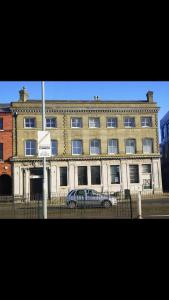 a large building with a car parked in front of it at Entire Two Bedrooms Flat with Nice View H2 in Great Yarmouth