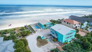 an aerial view of a beach with houses and the ocean at Ocean Beach Club in New Smyrna Beach
