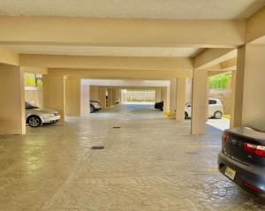 a garage with two cars parked in it at Punta Cana Seven Beaches in Punta Cana