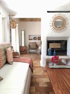 a living room with a couch and a fireplace at Casa Muro Luxury Villa in Cala Saona