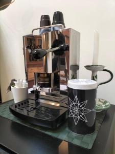 a coffee maker and a cup on a counter at B&B Chapo in Catania