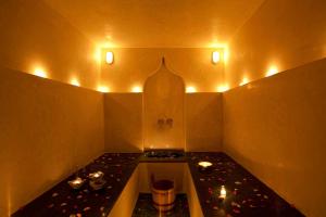 a room with a stove and a table with lights at Riad Les Bougainvilliers in Marrakesh