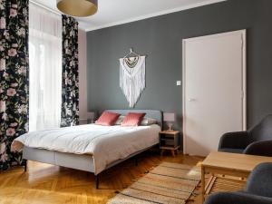 a bedroom with a bed with two red pillows at Apartament Zakatek z dwiema sypialniami in Bielsko-Biała