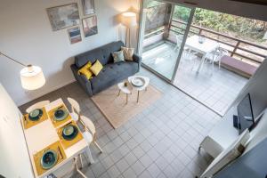 widok z góry na salon z kanapą w obiekcie Chaleureux appartement à 500m de l’océan et 150m du Golf Moliets-Plage w mieście Moliets-et-Maa
