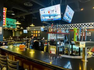 a restaurant with a bar and a bar counter at Comfort Suites Chicago O'Hare Airport in Schiller Park