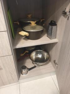 a cupboard with a pot and a pan on it at blue - comfy center rodos in Asgourou