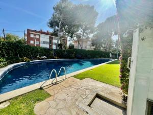 a swimming pool in a yard next to a house at LOVELY LOFT IN SITGES by hlclub HUTB-11931 SOC in Sitges