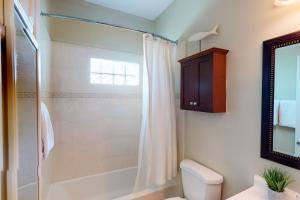 a bathroom with a shower and a toilet and a sink at El Ancla del Mar in South Padre Island +11 photos