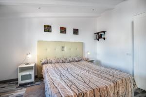 a bedroom with a large bed and a white wall at Villa Caldentey in Ariany