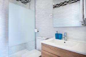 a bathroom with a sink and a toilet and a mirror at Villa Caldentey in Ariany +17 photos