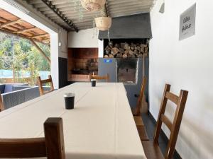 a kitchen with a table with chairs and a fireplace at Villas Pedroso: nature, mountains and the ocean in Cascais