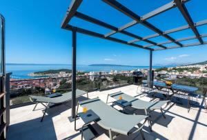 a view from the balcony of a building with tables and chairs at Vila Aurelia 2 in Makarska