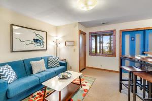 a living room with a blue couch and a table at Octopus Den in Coupeville