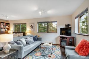 a living room with a couch and a tv at Osprey Nest in Coupeville