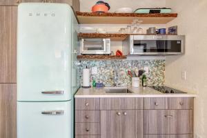 a kitchen with a white refrigerator in a room at Osprey Nest in Coupeville