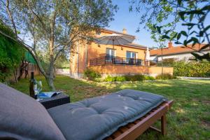 kanapę siedzącą na podwórku przed domem w obiekcie Holiday house TOIĆI w Krku