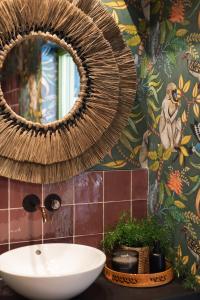 a bathroom with a sink and a mirror at El Jardin de Gala in Castejón de Monegros