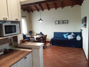 a living room with a blue couch and a table at The Gallipoli Houses in Eceabat