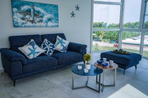 a living room with a blue couch and a table at NSM Blumarine Luxury home in Campomarino