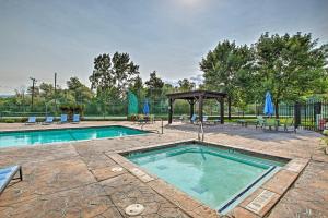 a swimming pool with a gazebo and a picnic table at High-End Huntsville Condo with Private Hot Tub! in Huntsville