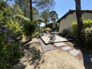 派拉索梅Villa au Pyla, Proximité Plage, Capacité 7 Pers. - FR-1-474-42的庭院设有两把椅子和一张桌子。