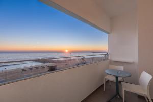 a room with a view of the beach and the ocean at Dom Jose Beach Hotel (Plus) in Quarteira