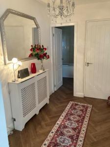 a living room with a mirror and a rug at fabulous sea views and sunsets in Morecambe