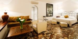 a living room with a bed and a couch at Hotel Punta Sur in Tarifa