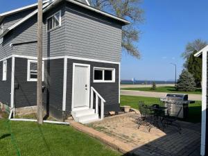 a small house with a picnic table and a grill at 3 Bedroom House with Lake Pepin views with access to shared pool in Lake City