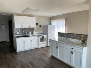 a kitchen with white cabinets and white appliances at 3 Bedroom Condo with Lake Pepin views with access to shared outdoor pool in Lake City