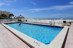 a swimming pool with a person in the water at Ram Sea I 301 in St Pete Beach