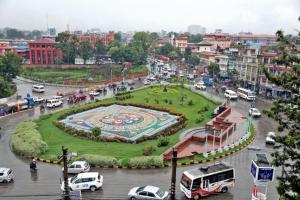 a city with a fountain in the middle of a street at Kathmandu Sojourn-Your home away! (2BHK Apartelle) in Kathmandu