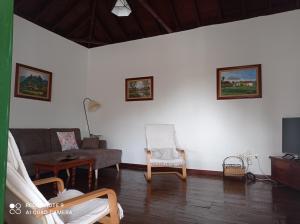 a living room with a couch and a chair at Casa PESTANA in Fuencaliente de la Palma